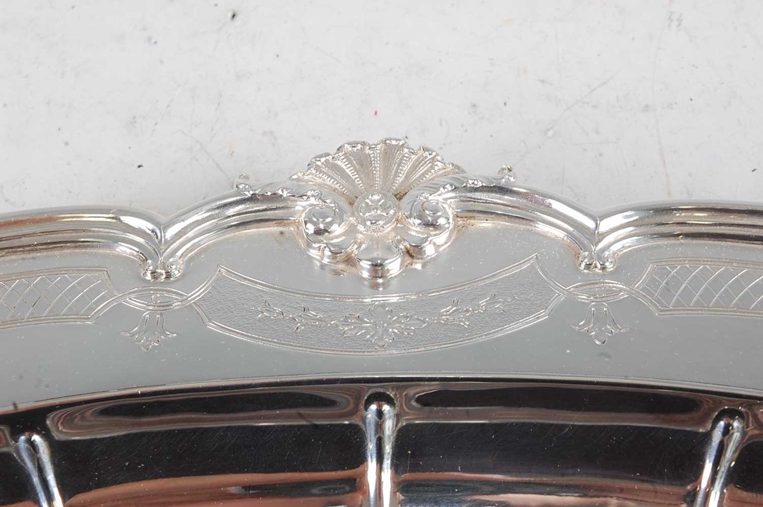 A George V silver meat dish, of oval form, the broad rim cast with C-scrolls and shells, further - Image 2 of 4