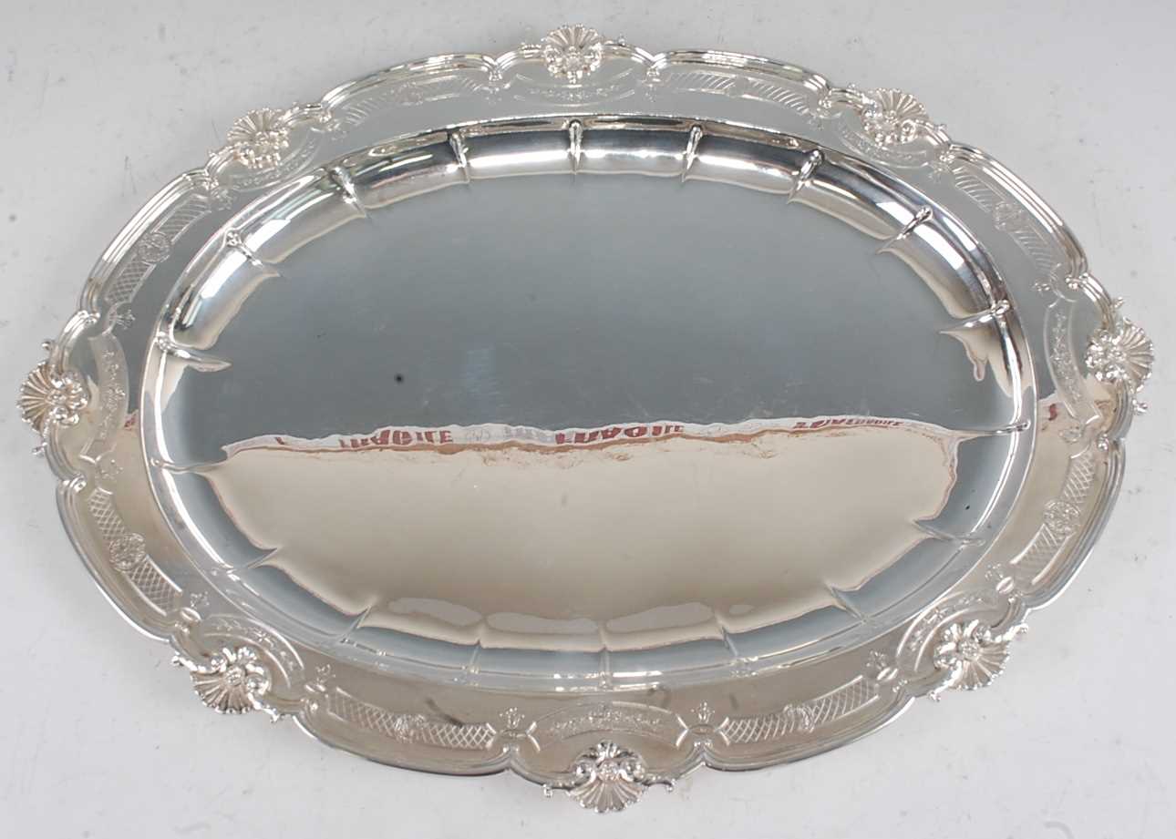 A George V silver meat dish, of oval form, the broad rim cast with C-scrolls and shells, further - Image 4 of 4
