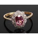 A yellow and white metal, spinel and diamond oval cluster ring, comprising a centre pink spinel