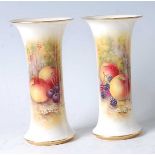 A pair of Worcester porcelain specimen vases, each of waisted trumpet form, decorated with fruit