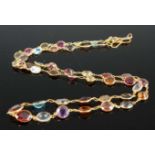 A yellow metal multi-stone necklet, comprising sapphire, lemon quartz, peridot, blue topaz, pink