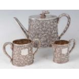 A matched 19th century Chinese white metal three piece tea service, comprising teapot, sugar bowl