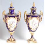 A pair of Lynton Porcelain Co pedestal vases and covers, each of classical urn shape, decorated in