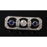 An Art Deco white metal sapphire and diamond panel brooch, featuring a centre Old European cut