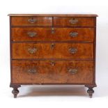An early 18th century walnut chest, the four quarter veneered crossbanded top over two short and