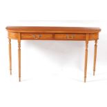 A satinwood D-end two drawer hall table, in the early 19th century style, all raised on ring