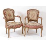 A pair of French giltwood fauteuil in the Louis XV style, each having upholstered backs, seats and