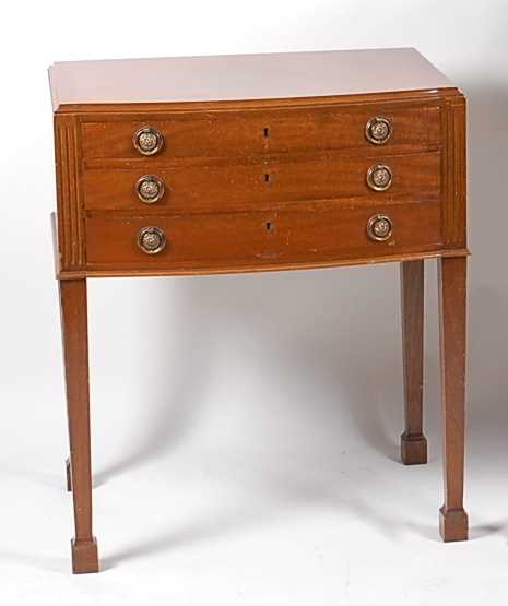 A mid-20th century Mappin & Webb mahogany three-drawer canteen table, containing a near-full