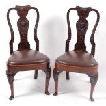 A pair of Queen Anne walnut dining chairs, having shaped top rails and vase splat backs, with carved