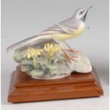 A Worcester porcelain model of a grey wagtail and celadine, modelled by Dorothy Doughty, No.182,