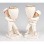 A pair of Hadley Worcester figures in the Kate Greenaway style, each modelled as a child holding a