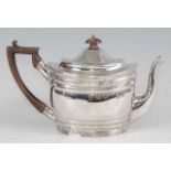 A George III silver teapot, having a finial topped hinged dome cover, bright cut engraved banded