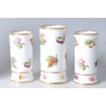 A set of three early 19th century Spode porcelain vases, each of cylindrical form, embossed with