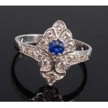 A white metal, sapphire and diamond navette shaped cluster ring, featuring a round faceted