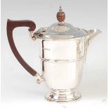A George V silver hot water pot, of ribbed and tapering circular form, 12.2oz, maker Adie Brothers