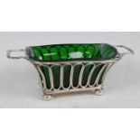 An Edwardian silver bonbon dish, having heavy green glass liner, the top with a reeded edge and twin