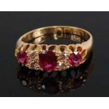 An early 20th century 18ct yellow gold, ruby and diamond seven-stone half hoop eternity ring,