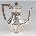 An Edwardian silver coffee pot, of pear shape with reeded frieze and apron, ebony handle, 20.2oz,