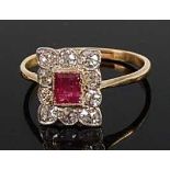 A yellow metal, ruby and diamond rectangular cluster ring, comprising a centre step cut ruby