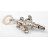 A George V silver and embossed rattle, having mother of pearl teether, 1.8oz, maker ES Barnsley & Co