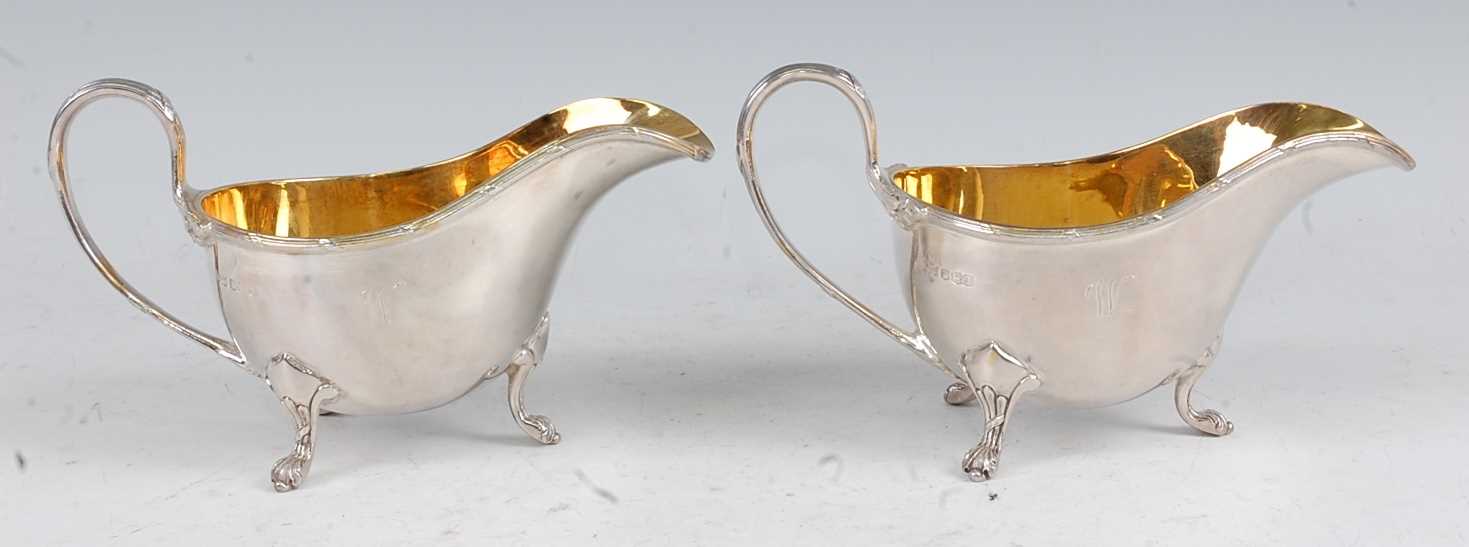 A pair of Mappin & Webb silver sauceboats, each having gilt-washed interiors, reeded edges, and on - Image 4 of 5