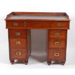A Victorian padouk twin pedestal campaign desk, the leather inset writing surface within a removable