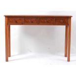 A figured walnut and crossbanded four drawer hall table, raised on chamfered square supports, w.