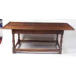 An antique oak refectory table, having a planked top with cleated ends over a rosette carved frieze,
