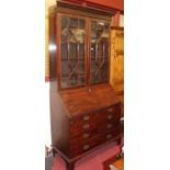 A George III mahogany bureau bookcase, the associated upper section having twin astragal glazed