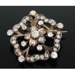 A late Victorian yellow and white metal diamond flower brooch, featuring forty-one Old European