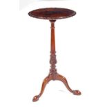 A mahogany pedestal wine table, in the George III manner, the top having a shaped and beaded edge to