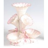 A second period Belleek porcelain Marine vase, having four trumpets over three conch-shells amidst