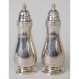 A pair of Mappin & Webb silver pepperettes, having pierced and domed screw tops over slender