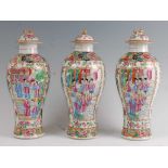 A set of three 19th century Chinese Canton vase and covers, each decorated in bright enamels in