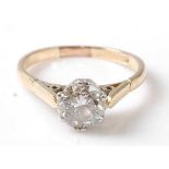 A yellow and white metal diamond single stone ring, featuring a round brilliant cut diamond in a