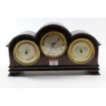 A burr walnut cased mantel clock, the case of domed rectangular form, the central silvered dial with