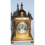 A late 19th century brass cased mantel clock having a circular silvered dial with Roman numerals and