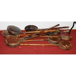 A collection of various 19th century and later copper warming pans together with a hunting horn