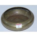 A Chinese bronze bowl of squat circular form with incised dragon decoration with impressed seal mark