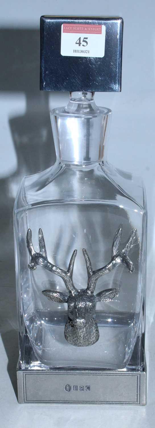 An English Pewter Company glass decanter mounted with a pewter stag's head with a further pewter