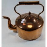 A large early 20th century polished copper range kettle and cover, the cover with acorn finial,