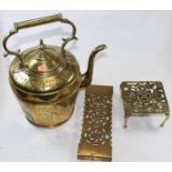 A large decorative brass kettle with floral engraved decoration, height 38cm, together with two