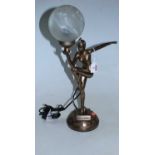 An Art Deco style bronzed resin table lamp in the form of a nude dancer in standing pose with