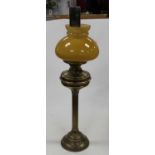 A large brass range kettle together with a brass oil lamp with yellow tinted glass shade and a