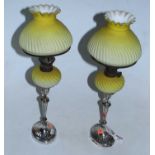 A pair of late Victorian silver candle sticks, each converted into oil lamps with moulded yellow