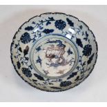 A Chinese stoneware bowl, of shaped circular form, underglaze blue decorated with band of flowers