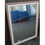 A reproduction gilt framed and bevelled wall mirror, 117 x 90cm