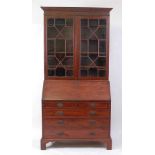 A George III mahogany bureau bookcase, the associated upper section having twin astragal glazed