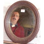 A carved hardwood framed oval wall mirror, 37 x 32cm; together with an unframed bevelled wall mirror