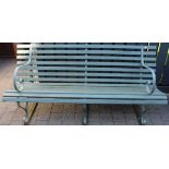 A wrought iron and painted wood slatted three seater garden bench in the Victorian taste, length